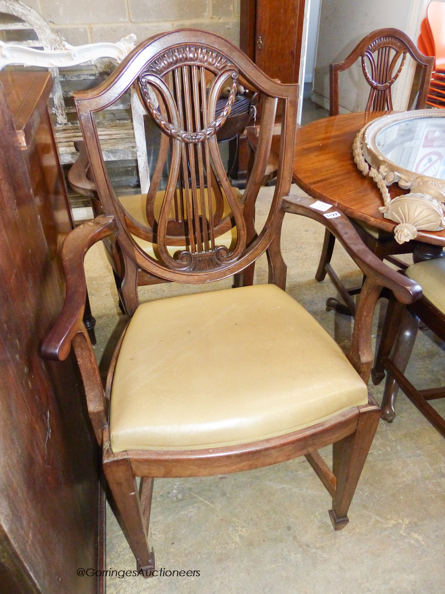 A set of six Hepplewhite style mahogany dining chairs, two with arms